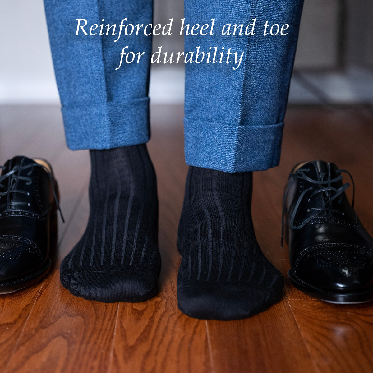 man wearing black ribbed cotton dress socks standing on hardwood floor