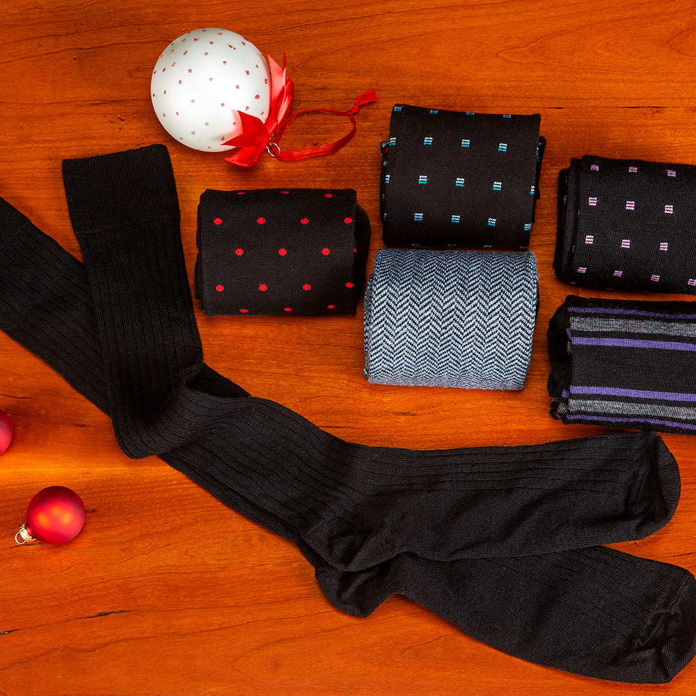 black dress socks for the holidays from Boardroom Socks atop a cherry tabletop