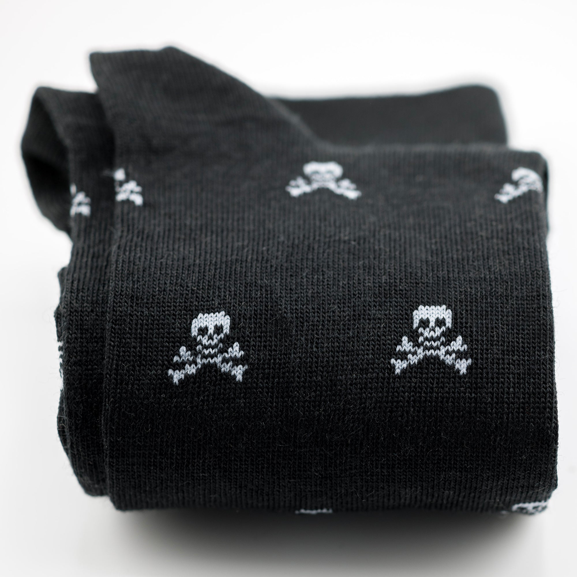 pair of black wool dress socks decorated with skull and bones