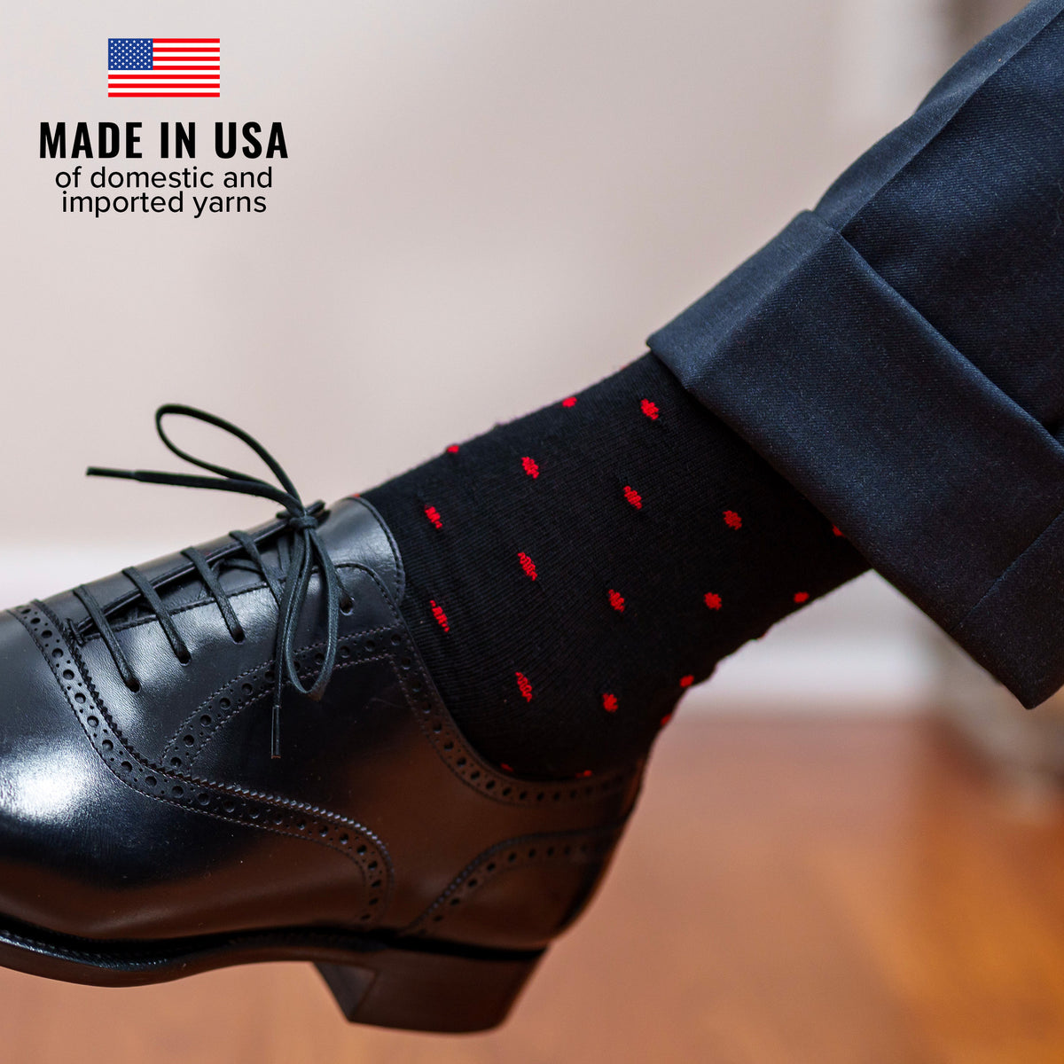 black dress socks with red polka dots paired with charcoal slacks and black oxfords