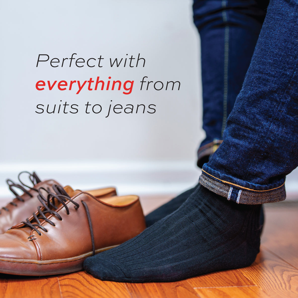 man wearing jeans and black merino over the calf dress socks with perfect with everything text overlay