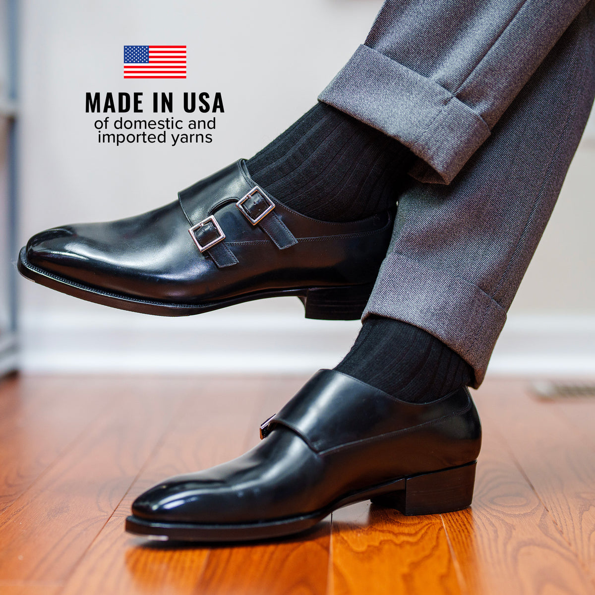 man wearing black merino wool dress socks crossing legs