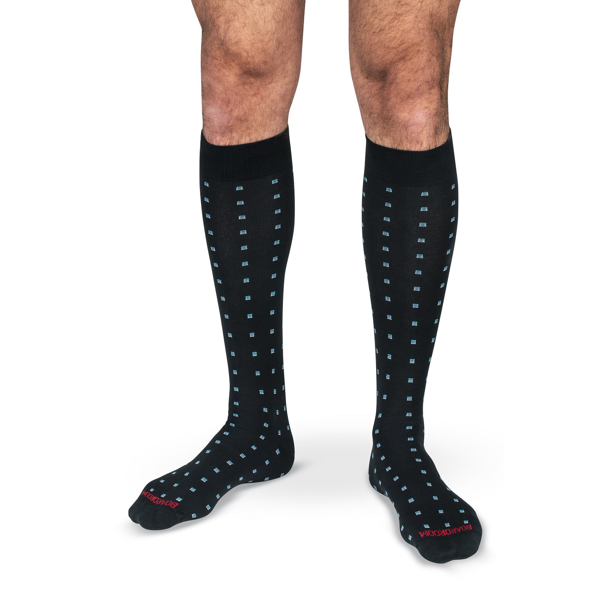 model wearing black cotton over the calf dress socks decorated with blue geometric pattern