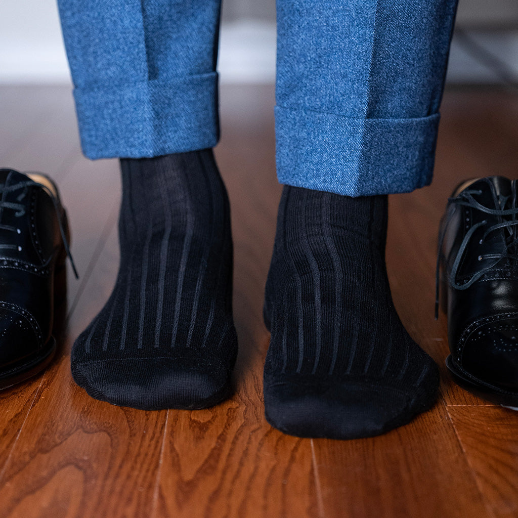 black ribbed cotton dress socks with light blue trousers and black oxfords