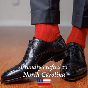 red dress socks paired with dark grey slacks and black cap toe oxfords