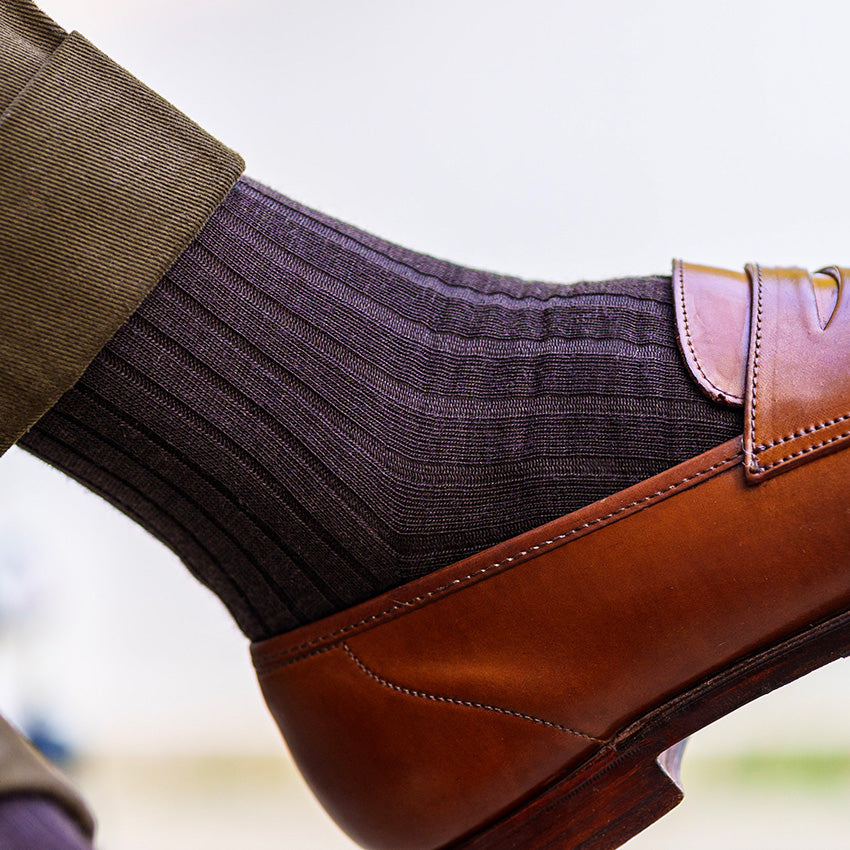 men's brown dress socks paired with olive trousers and brown penny loafers