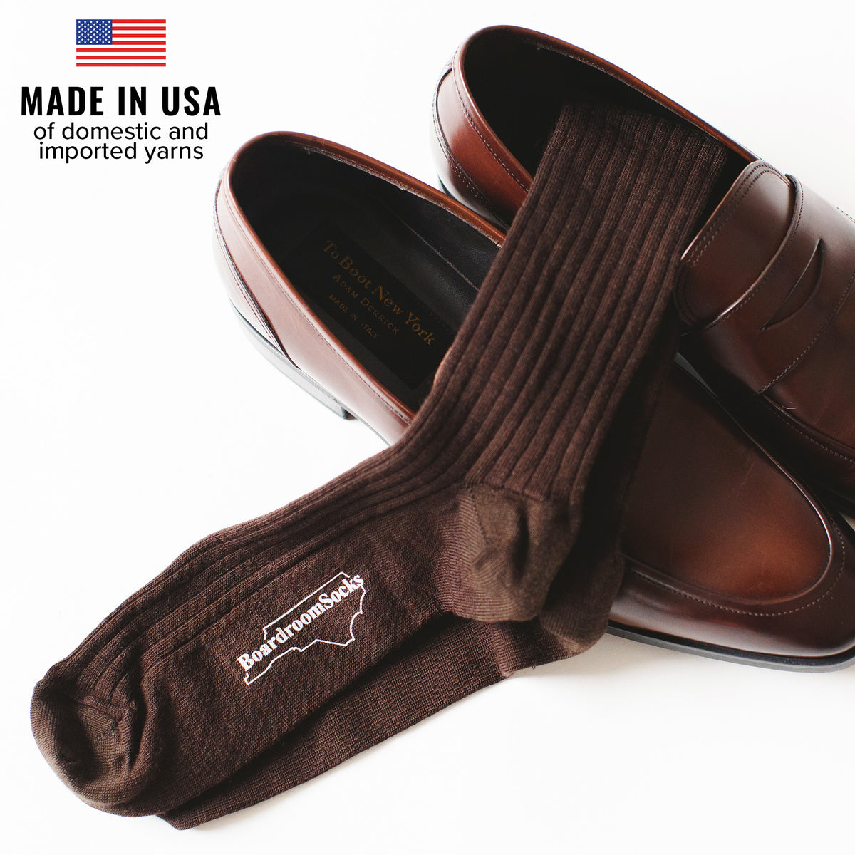 pair of brown merino wool dress socks atop brown penny loafers