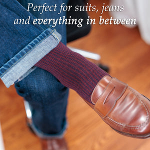 man wearing burgundy and navy houndstooth dress socks with jeans and brown penny loafers