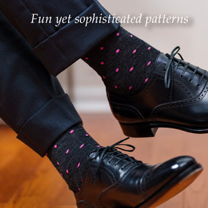 man crossing legs showing charcoal grey dress socks with pink dots