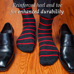 man wearing charcoal grey dress socks decorated with bright red horizontal stripes