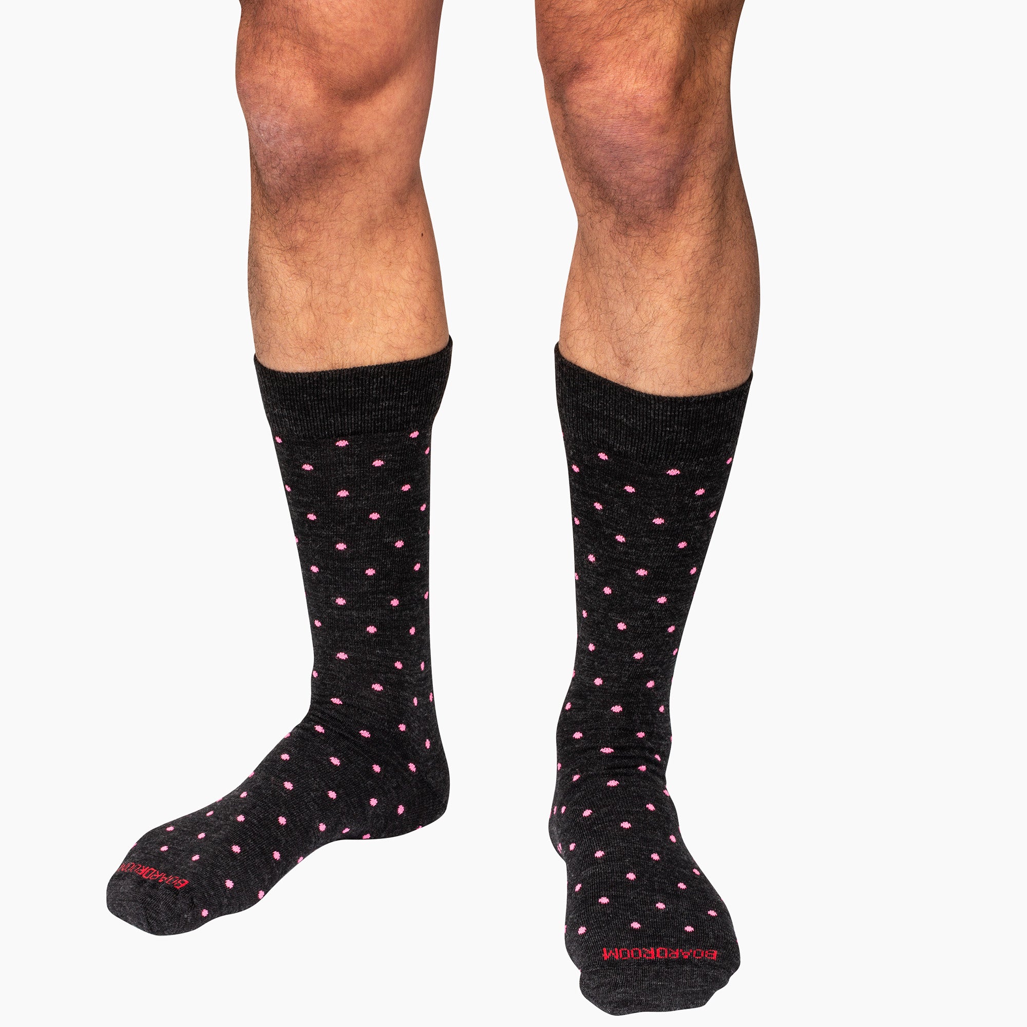 model wearing charcoal grey wool dress socks decorated with bright pink dots