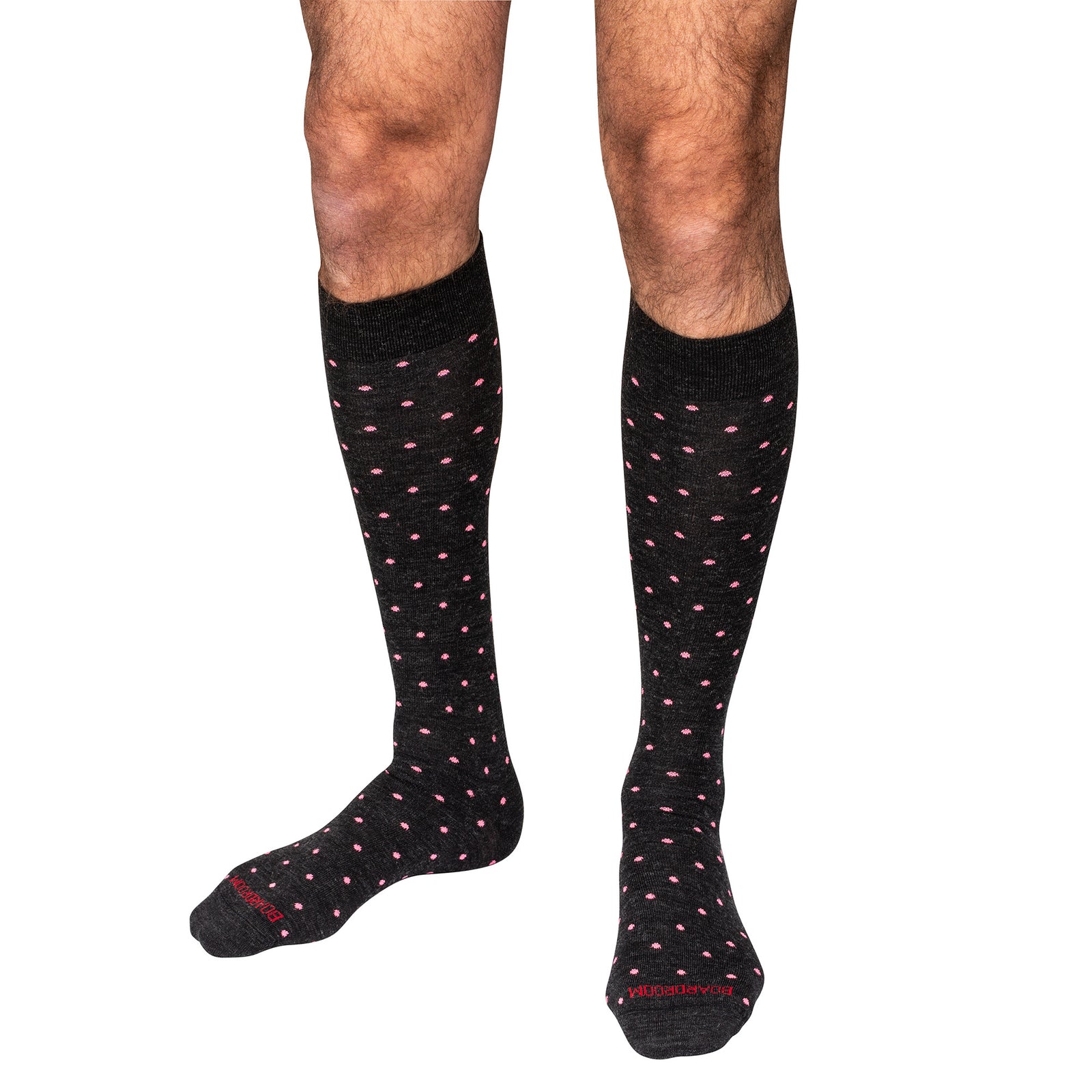 charcoal knee-high dress socks with pink polka dots worn by a person on a white background