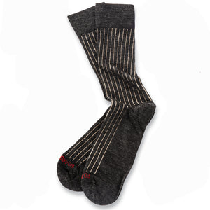 pair of charcoal grey merino wool shadow stripe dress socks on white tabletop