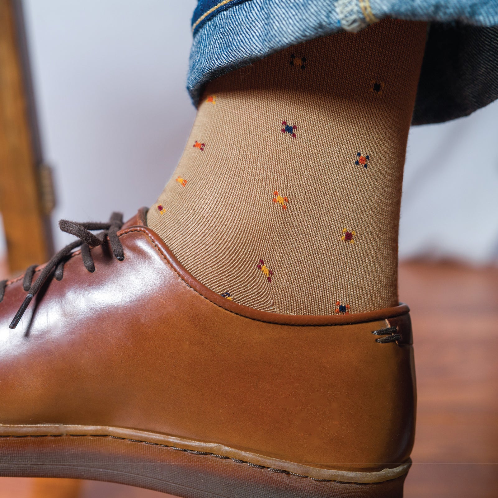 very close up image of man wearing brown shoes and Khaki Geometric Merino Wool Over the Calf Dress Socks