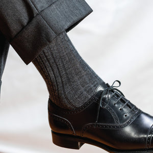 man wearing grey pants, black shoes and grey heather merino wool dress socks 
