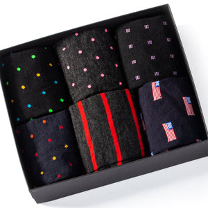 opened gift box showing six pairs of colorful merino wool patterned dress socks