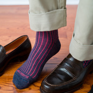 man wearing coral and denim shadow stripe dress socks with khakis and brown leather penny loafers