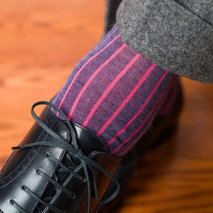 man wearing coral and denim wool shadow stripe dress socks with grey slacks and black oxfords