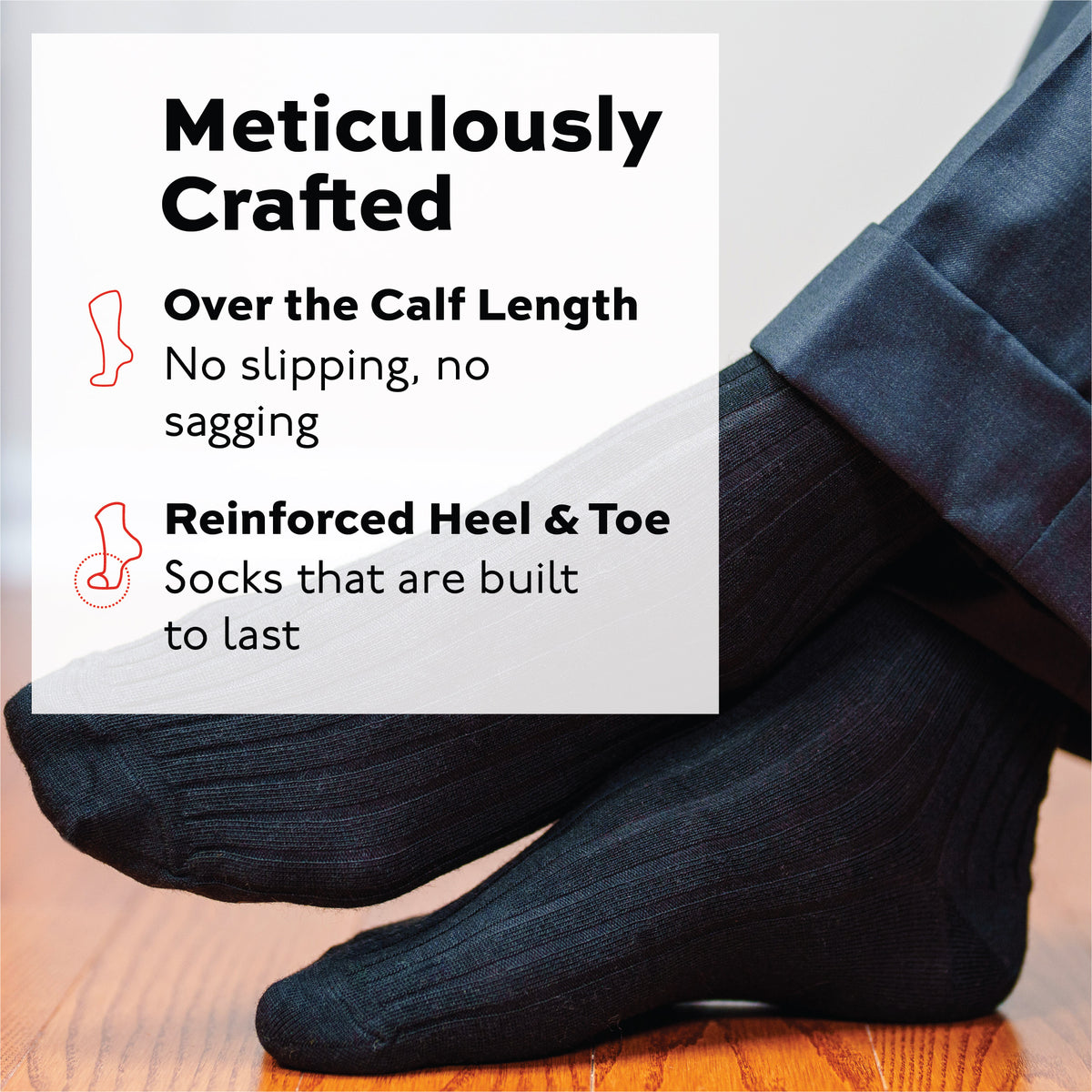 man crossing legs wearing black merino wool over the calf dress socks and nice pants