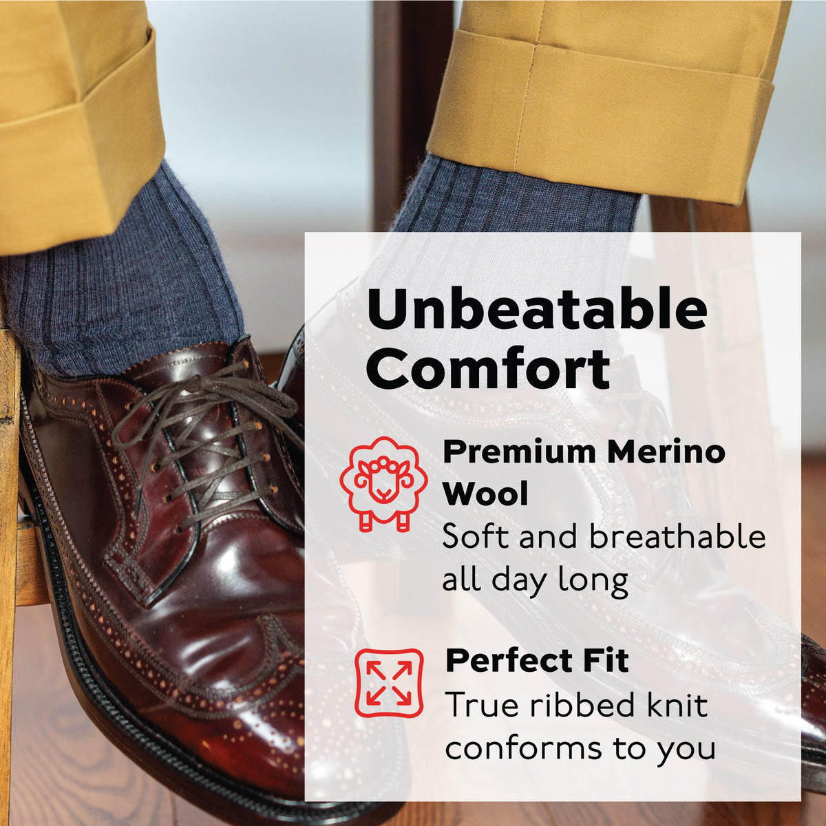 denim merino wool over the calf dress socks worn by a man sitting on a stool wearing oxfords