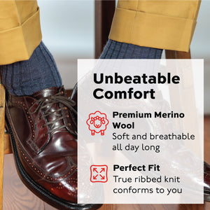 denim merino wool over the calf dress socks worn by a man sitting on a stool wearing oxfords