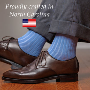 light blue ribbed dress socks with brown wholecut oxfords and a grey windowpane suit