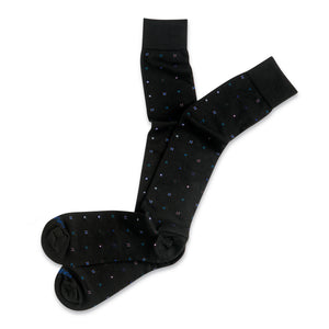 black geometric pattern cotton over the calf socks laying flat on a white background