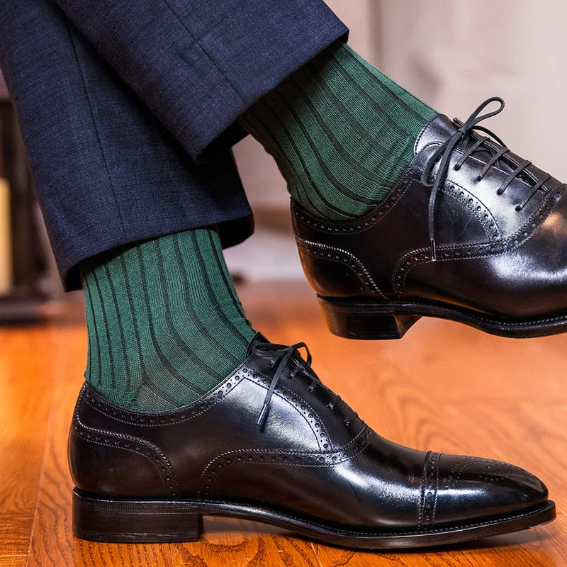 man wearing navy pants, nice black shoes and Merino Wool Mid-Calf Dress Socks in forest green