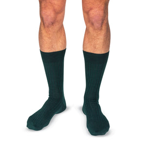 model wearing Forest Green Merino Wool mid-Calf Dress Socks on a white background