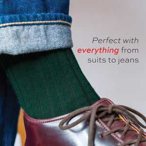 close up image of a man wearing Forest Green Merino Wool Over the Calf Dress Socks with text overlay