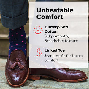 man standing on a stone path wearing nice brown dress shoes and navy cotton cotton socks with pink dots