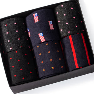 black gift box filled with six pairs of colorful merino wool dress socks