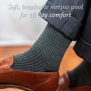 man wearing olive and navy houndstooth dress socks with charcoal suit and brown penny loafers