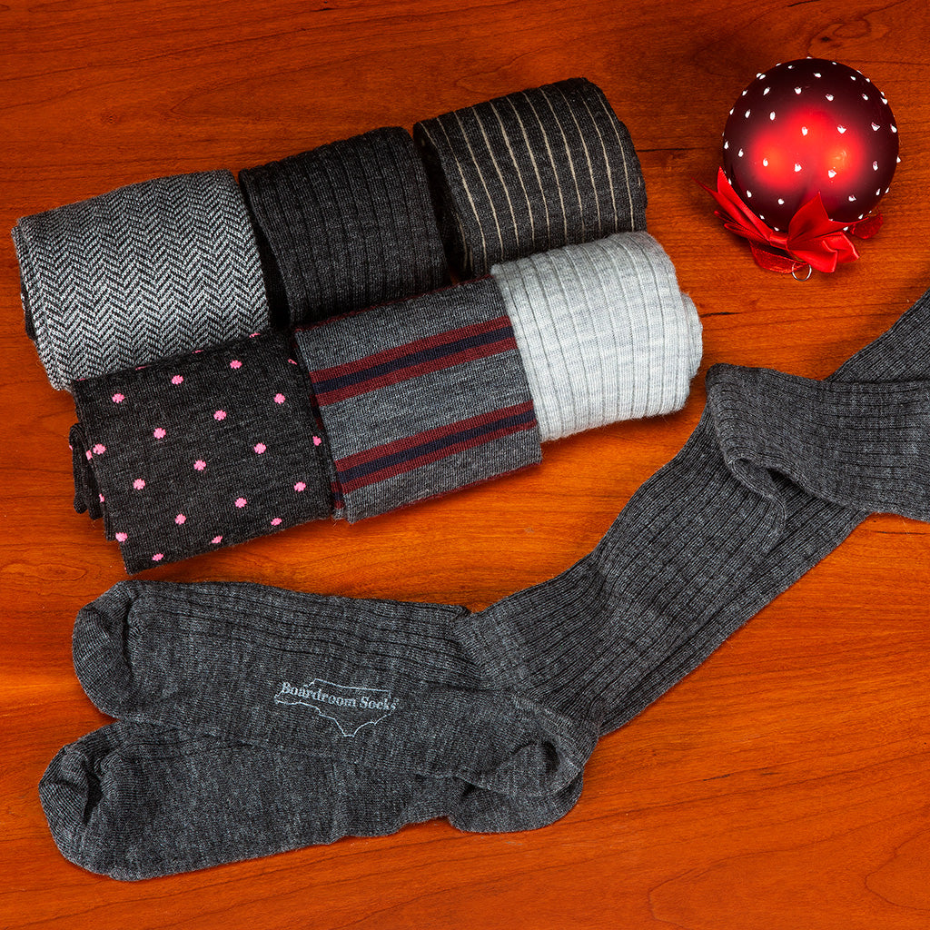grey dress socks for the holidays from Boardroom Socks atop cherry tabletop