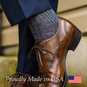 man crossing ankles wearing grey heather merino wool dress socks with navy slacks