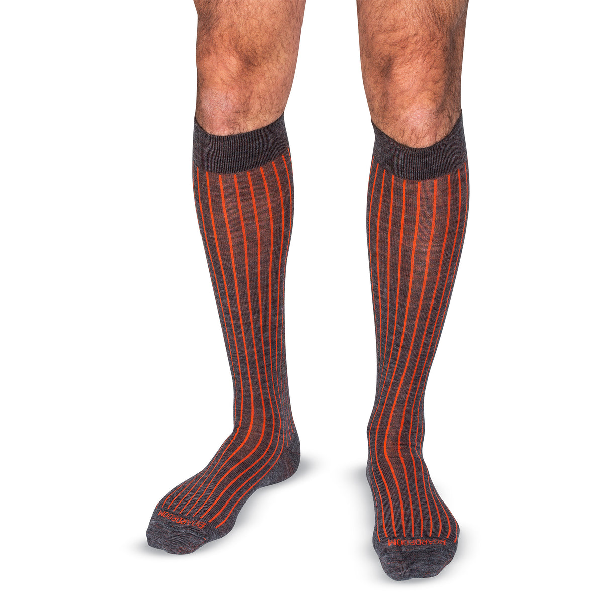 model wearing grey and orange shadow stripe over the calf length dress socks