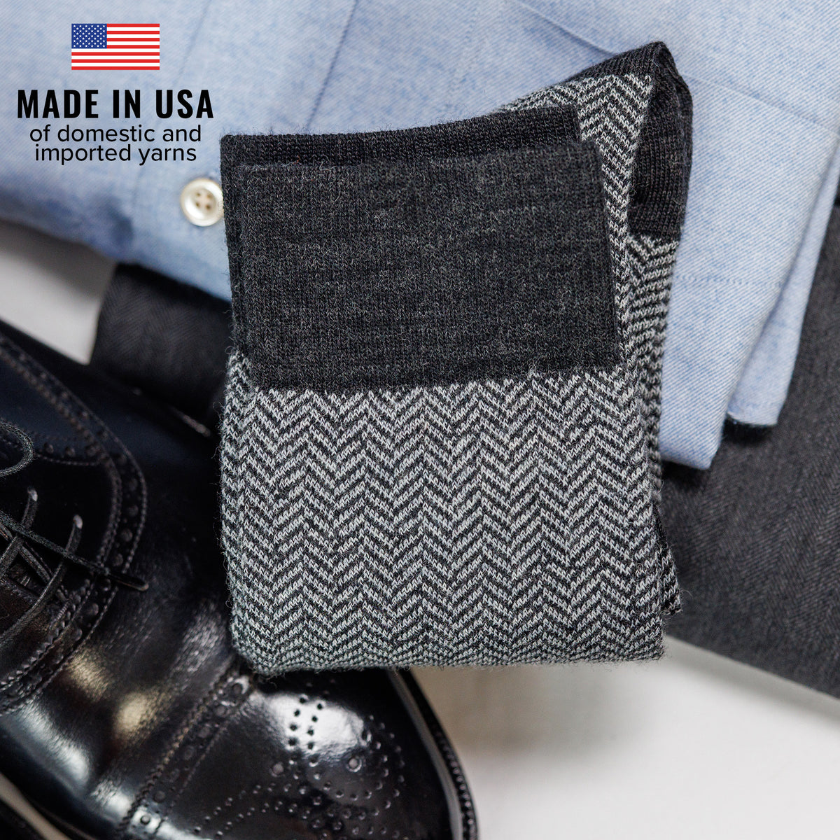 pair of grey herringbone dress socks atop business casual outfit