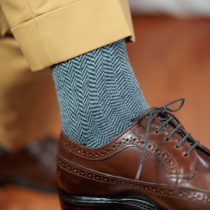 man wearing khaki slacks and brown wingtips with grey herringbone dress socks