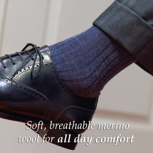 man wearing heather blue wool dress socks with a charcoal suit and black oxfords