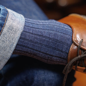 man wearing heather blue wool dress socks and jeans with brown leather sneakers