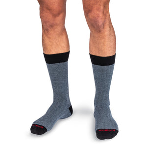 model wearing light blue and black herringbone dress socks