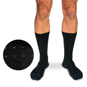 legs of a model on a white background wearing mid calf geometric cotton dress socks