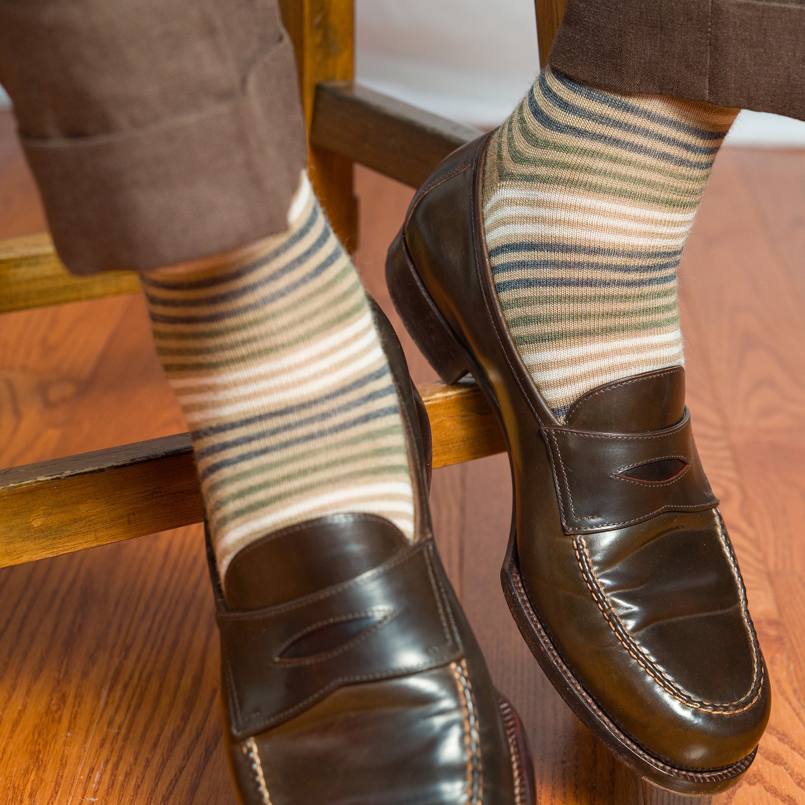 tan striped merino wool dress socks worn with brown slacks and brown penny loafers