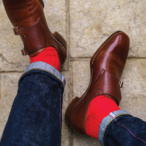 red merino wool mid-calf socks being worn with jeans and nice shoes