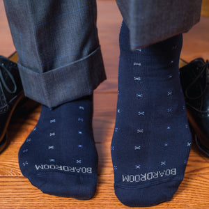 man standing on hardwood floors wearing boardroom socks navy over the calf cotton geometric dress socks