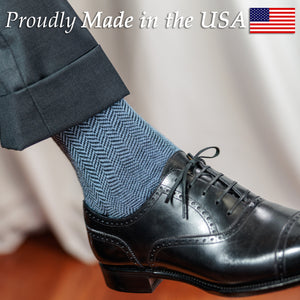 light blue and black herringbone dress socks with dark grey suit and black oxfords