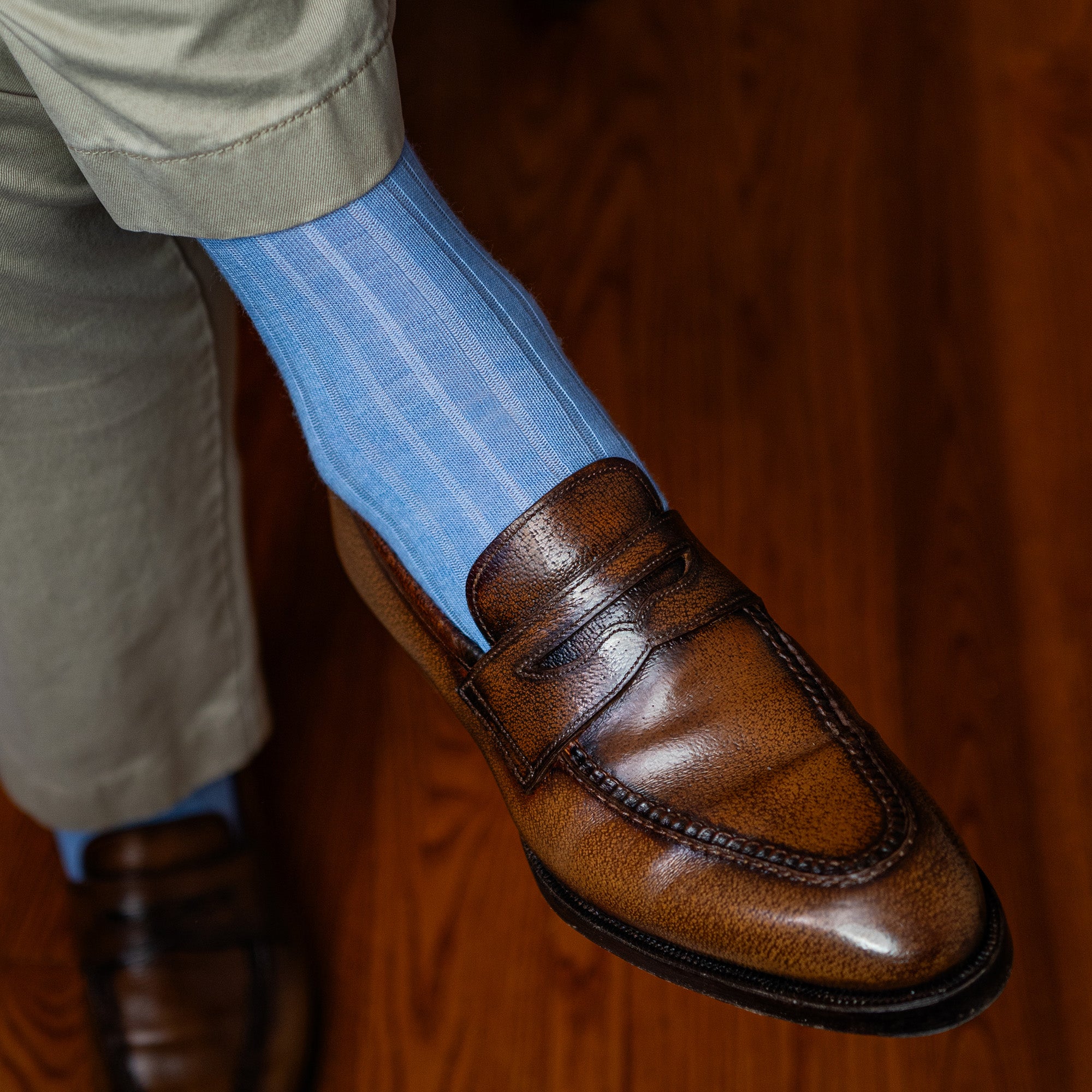 man wearing light blue wool dress socks crossing legs