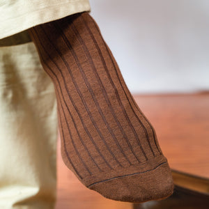 close up image of mans foot wearing Light Brown Merino Wool Mid Calf Dress Socks and khakis
