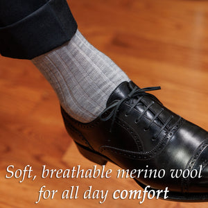 man wearing light grey heather dress socks with black oxfords and charcoal suit