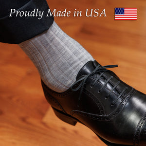 man wearing light grey heather wool dress socks with charcoal suit and black oxfords